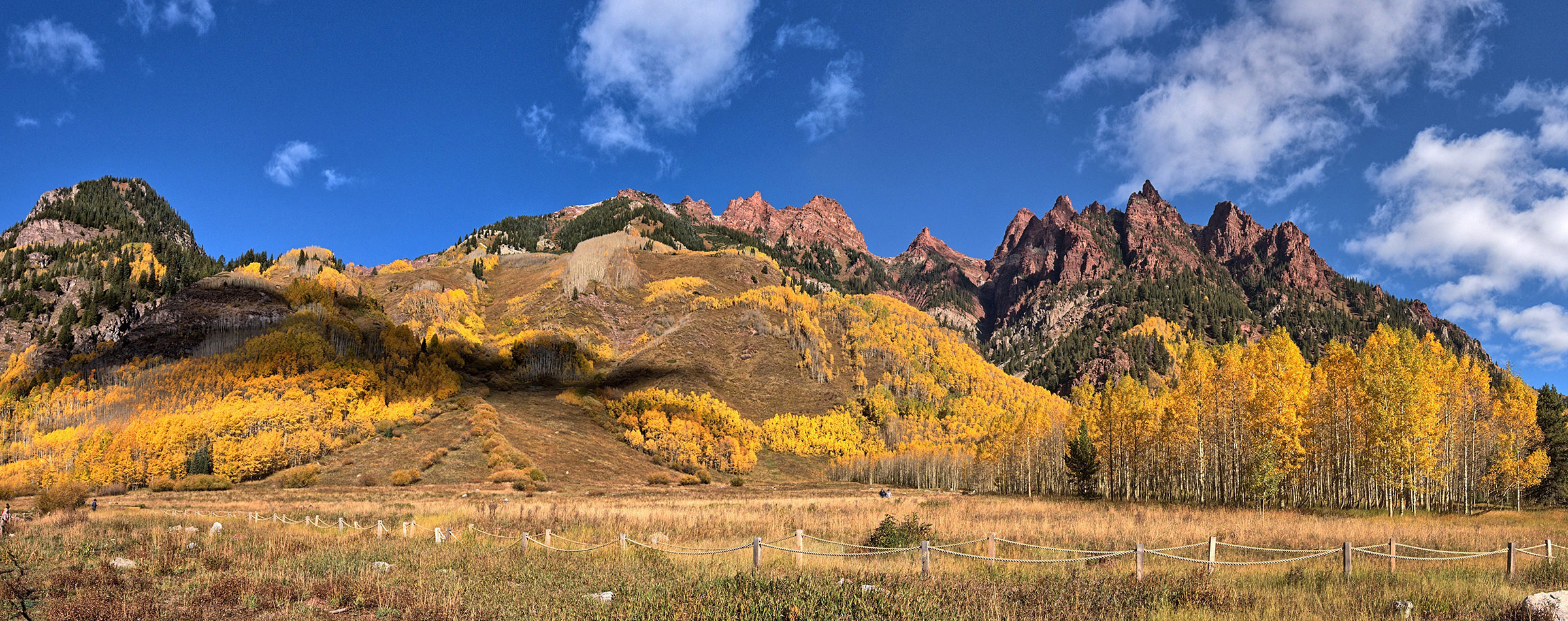 Peaks of Maroon Formation (red shale) and aspen trees along the edge of the Maroon Amphitheater Area.