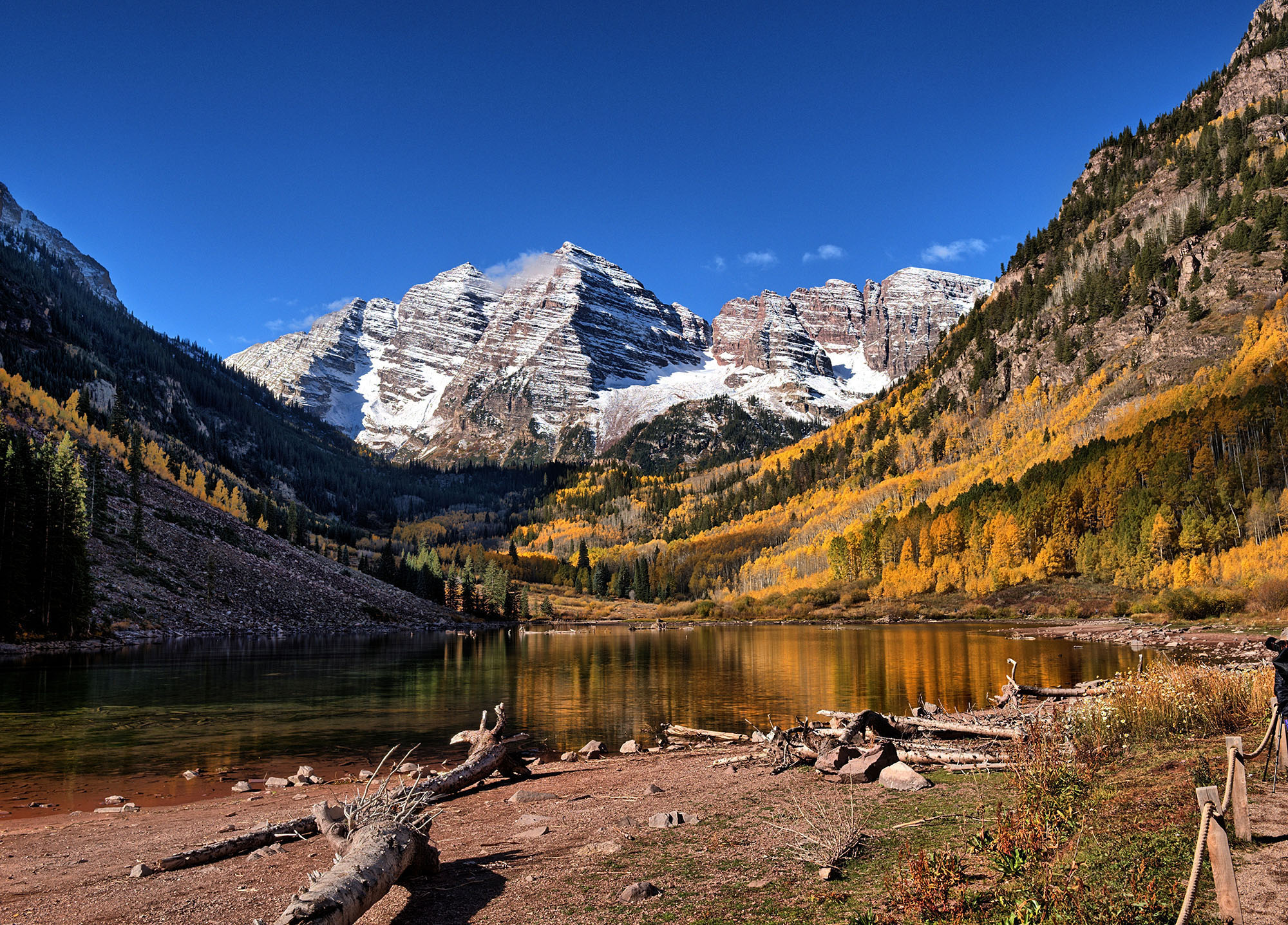 The Maroon Bells in the Aspen area above Maroon Lake are formed by Maroon Peak and North Maroon Peak over 14,000 feet high.  They are topped by layers of oxidized hematite-rich shale that formed during the Permian and Pennsylvanian periods (252-320 Ma) that was raised during the collision of Africa and North America to form Pangea and tilted during the Laramide orogeny (72-40 Ma).