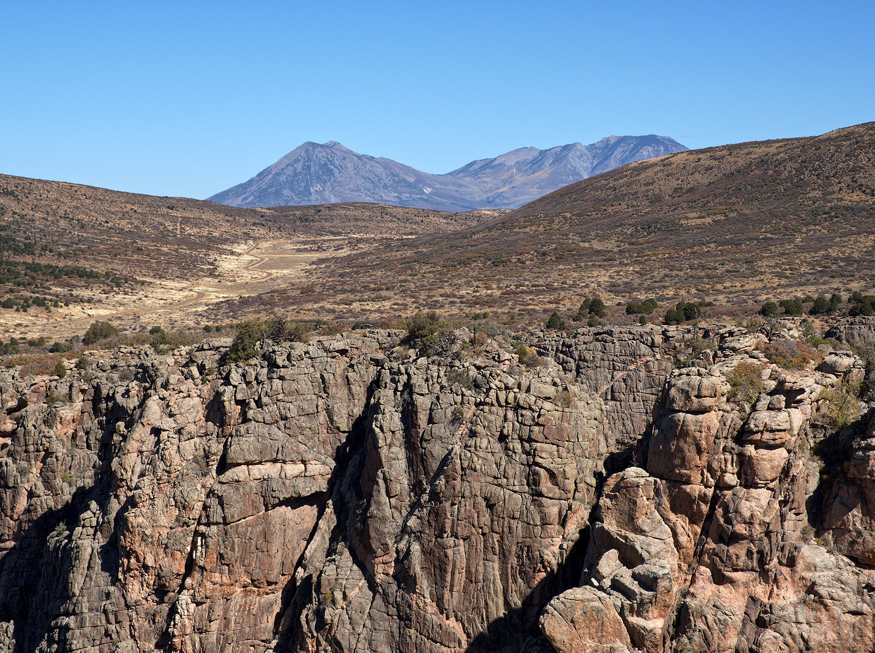 Three geologic formations:  Bottom – Black Canyon of the Gunnison gneiss and pegmatite (1.8 to 1.4 billion years); Middle: Mesozoic eroded sediment (60-90 Ma); Top – Igneous laccoliths of Landsend Peak (left) and Mount Lamborn (right) (~11,000’), West Elk Mountains (23-33 Ma) intruded into sediment and then eroded to igneous rock.