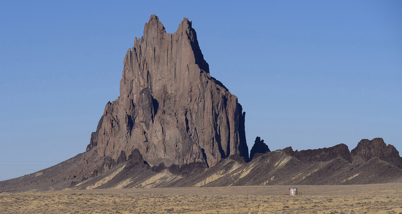 Shiprock, Shiprock NM:  This is a remnant of a diatreme (brecca filled volcanic vent formed by volcanic explosion) formed 25 -35 million years ago.  A volcanic dike extends South from the diatreme.  Erosion has resulted in removal of approximately 3,000 feet soil and volcanic material around the diatreme.