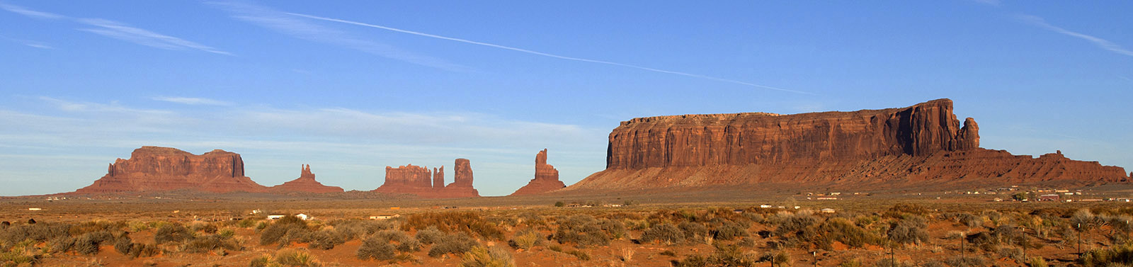 Monument Valley Arizona, Sedimentary layers of sandstone, shale and conglomerate deposited in the late Permian age were uplifted during the Laramide orogeny.  The surrounding layers have been eroded by the flows of the San Juan and Colorado rivers to leave flat-topped landforms.