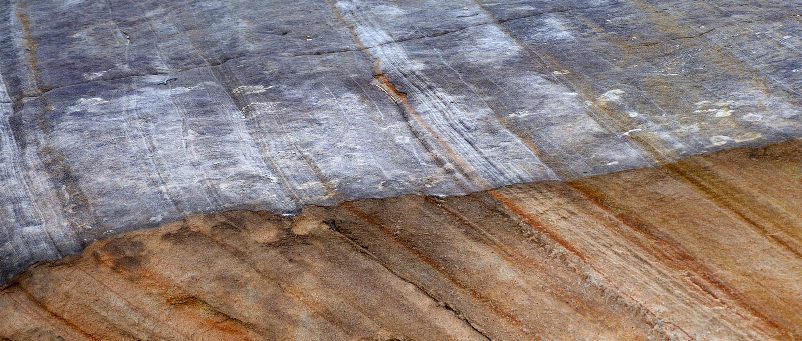 Checkerboard Mesa, fractured edge of sandstone layers derived from quartz sand deposited and moved by wind and water.