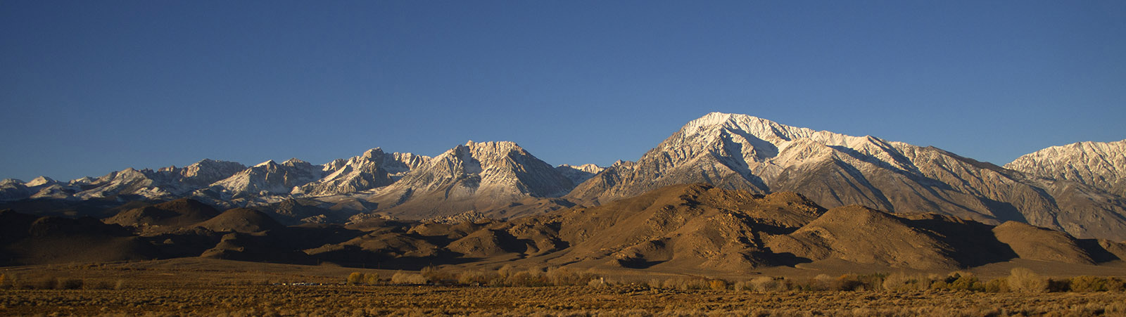Snow dusted peaks of the Sierra Nevada near Bishop CA.  The Alabama foothills composed of both granite and other igneous rock are in the foreground.