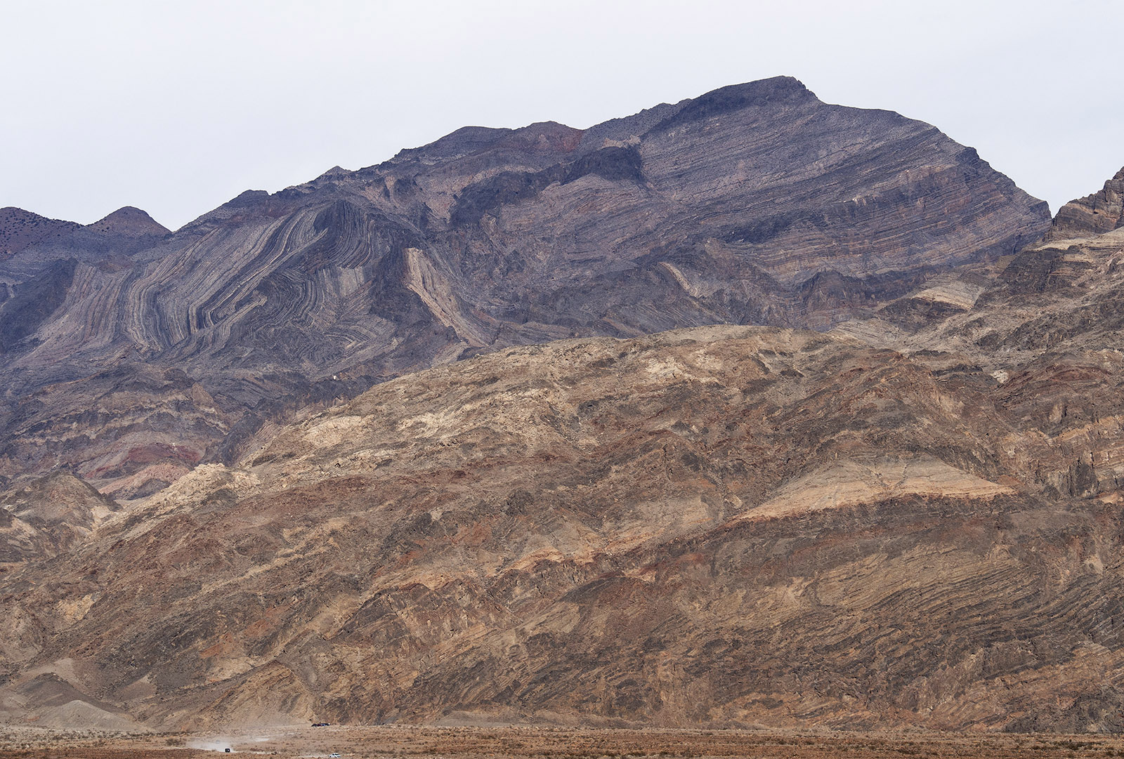 Grapevine Mountains at the exit of Titus Canyon.  There are marked distortions and folding of Paleozoic strata.  In the lower right, the Bonanza King Formation is overturned.