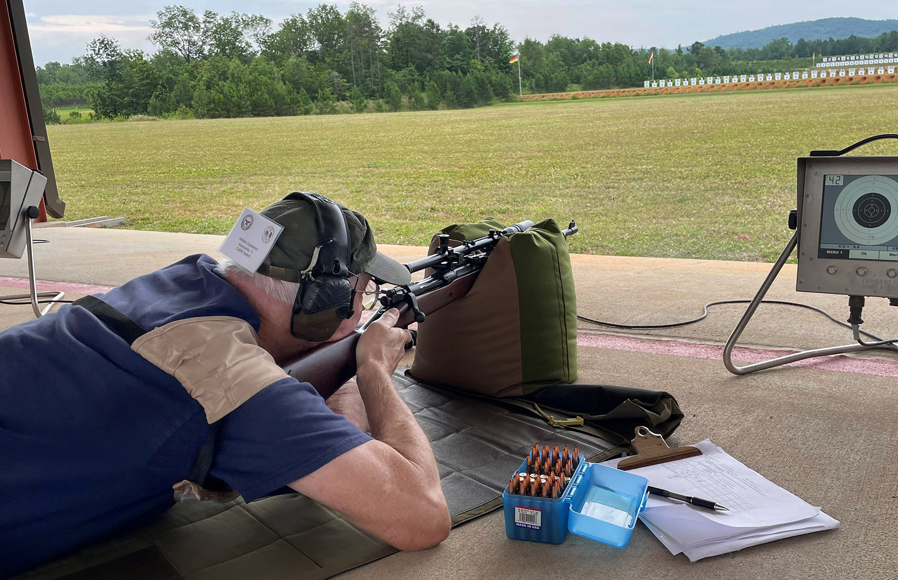 At the Vintage Sniper Match with my 1941A1 Springfield.  The 1941A1 Springfield issued by the USMC was the best long-range sniper rifle fielded by US Armed Forces during WW2.  My rifle was built from an original, as-issued 1934 Springfield Armory 1903A1 and a Hi-Lux replica of a Unertl 8X rifle scope.  I shot my personal best in a vintage sniper match on the 300 and 600 yd course (194-3X out of 200 – 97%) to record the 5th highest individual score of 76 competitors at the match.
