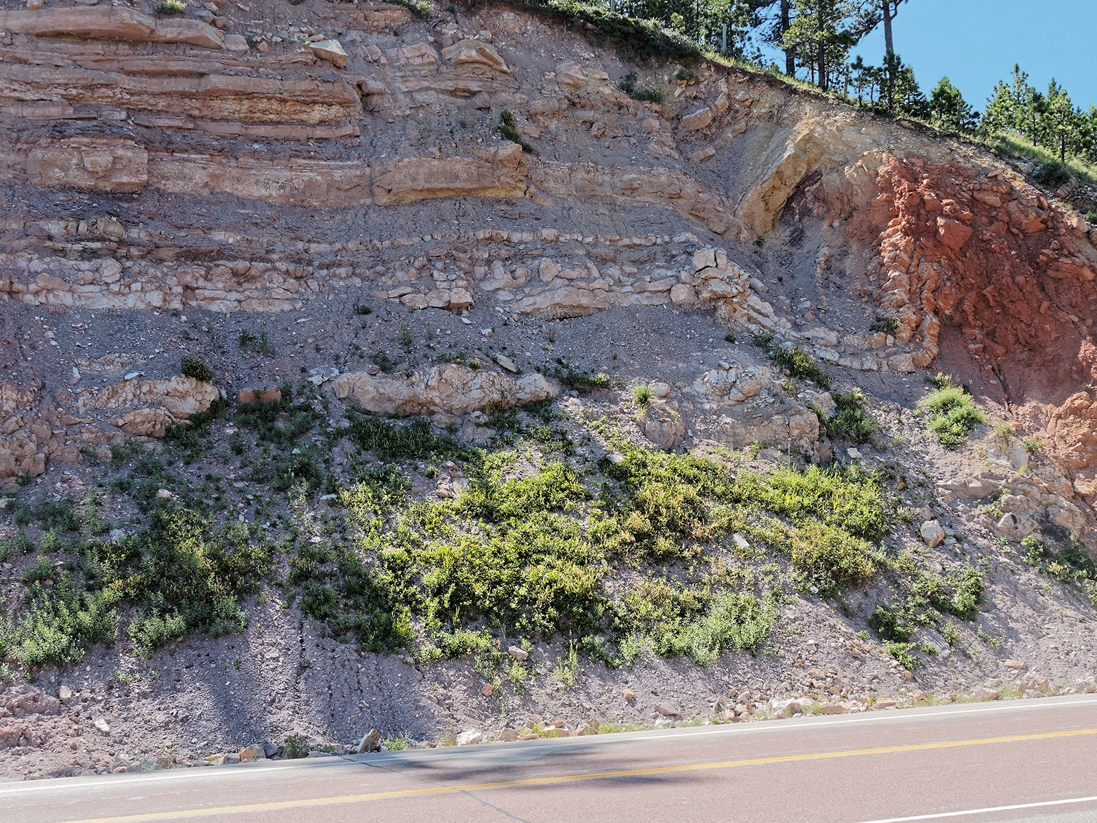 The dip in the strata in the right side of the field is a syncline along a small fault cutting the Amsden formation.