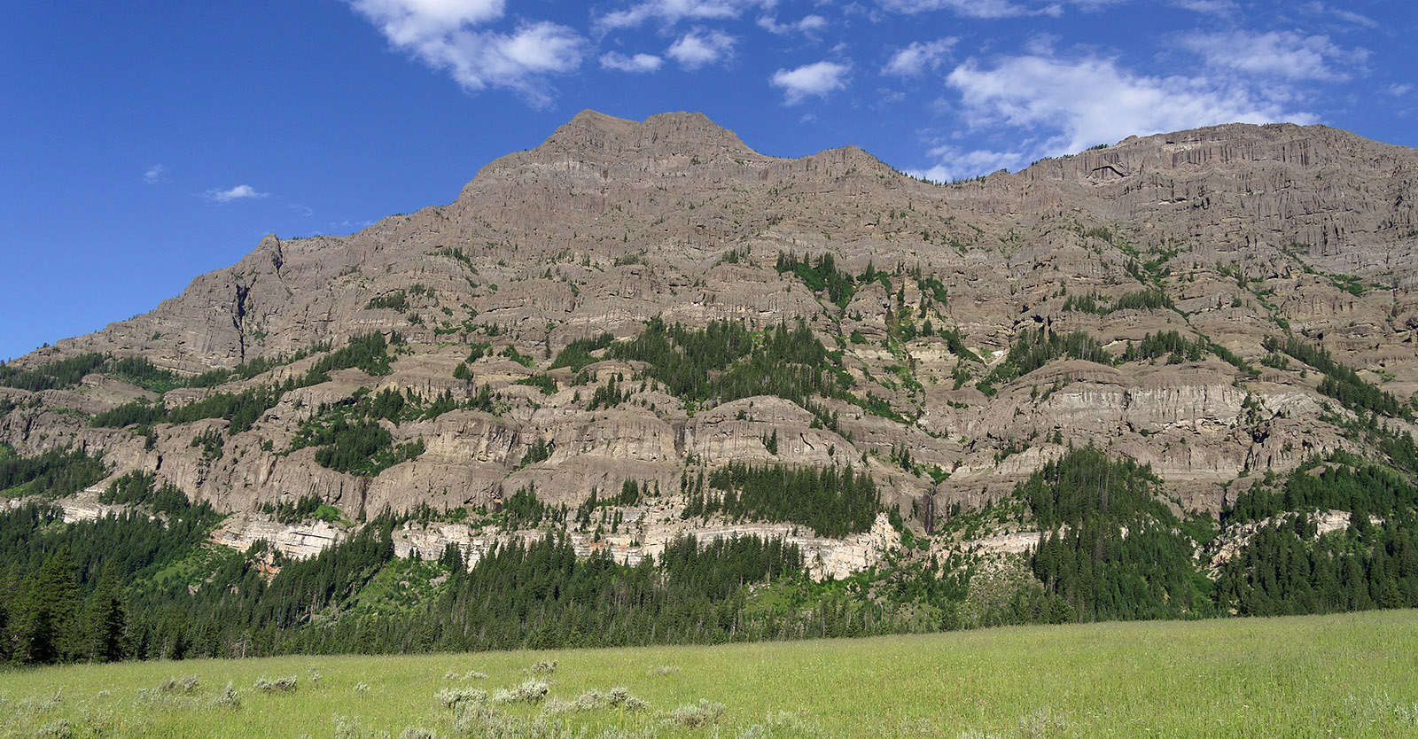 Barronette Peak at the eastern entrance to Yellowstone National Park formed from epiclastic material and air-fall tuff that originated from several andesitic volcanoes in the Absaroka Volcanic Supergroup that were active 20-30 million years prior to Yellowstone eruptions.
