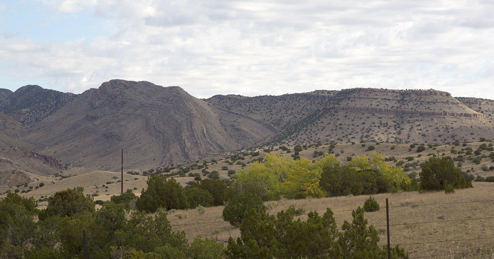 Uplifted, tilted and folded sedimentary strata in the southern end of the Manzano Mountains next to US Hwy 60.