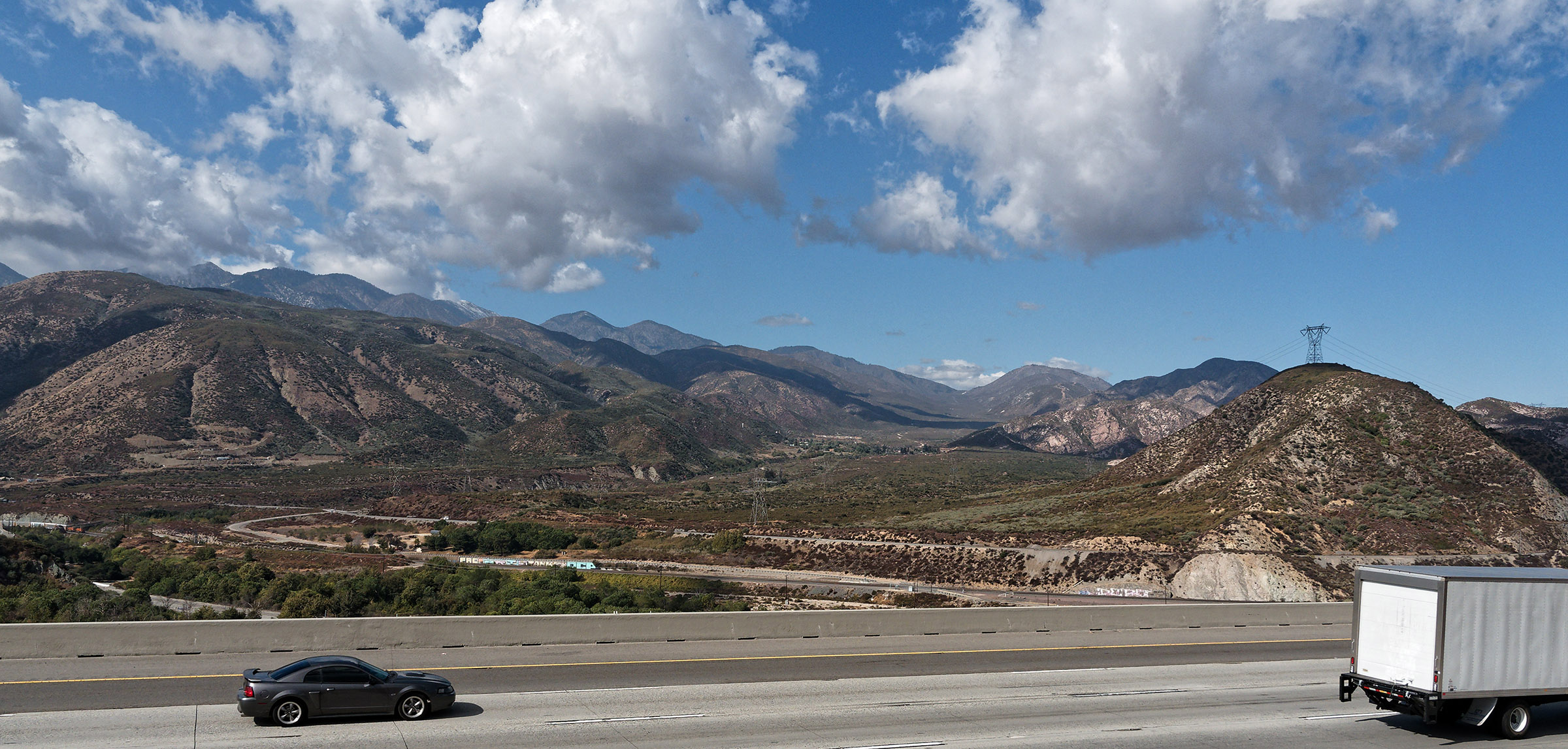 This photo was taken from a small hill next to Interstate-15 in Cajon Pass between the San Bernardino and San Gabriel Mountains.  The photo is facing Northwest looking up Lone Pine Canyon where the San Andreas Fault runs.  See next photo that is labeled.