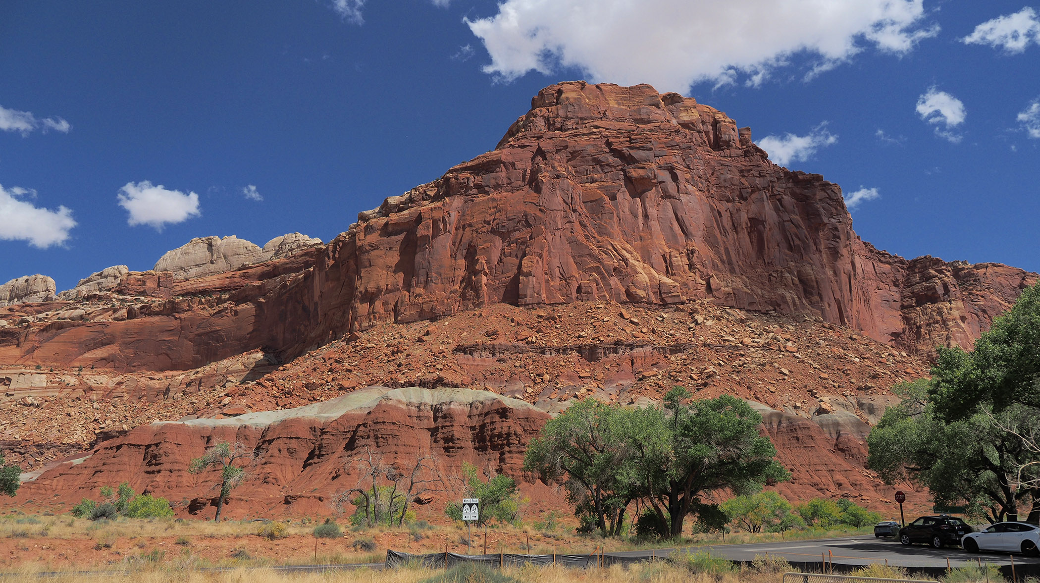 Entrance to the Capitol Reef National Park Visitor Center.  Center parking and the scenic road were closed for construction.  My white Tesla model 3 is parked outside the Visitor Center and Moenkopi rock formations are across US highway 24.